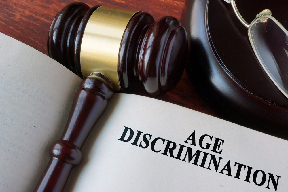 Gavel on top of book with Age Discrimination chapter French Parent Company Potentially Liable on Alleged ADEA Claim on a Single-Employer Theory