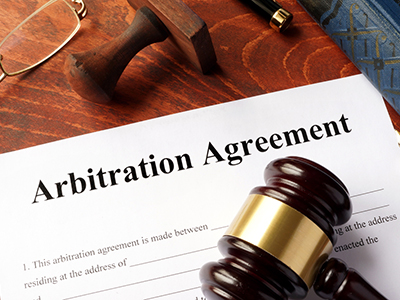 Arbitration agreement form on an office table DOJ Flips the Switch on Class Waivers in Arbitration Agreements, Signaling Possible Changes to Come